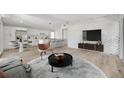 Contemporary living space with open floor plan, modern brick wall, and sleek kitchen at 4720 50Th N Ave, St Petersburg, FL 33714