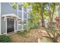 Inviting front entrance to a two-story home featuring a well maintained yard and beautiful trees at 506 S Willow Ave # 7, Tampa, FL 33606