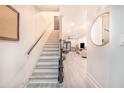 Bright and airy hallway with stairs leading to the upper level, showcasing modern flooring and neutral decor at 506 S Willow Ave # 7, Tampa, FL 33606