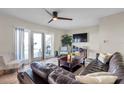 Spacious living room with modern ceiling fan, comfortable seating and access to outdoor patio at 5101 Coquina Key Se Dr # A, St Petersburg, FL 33705