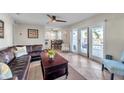Comfortable living room with tile flooring, ceiling fan and sliding glass door to the patio at 5101 Coquina Key Se Dr # A, St Petersburg, FL 33705