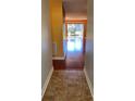 Hallway view leading into a bright open living space with wood flooring and a sliding glass door at 6070 80Th N St # 109, St Petersburg, FL 33709