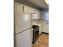 Bright kitchen with stainless steel stove, microwave, and ample cabinet space at 6070 80Th N St # 109, St Petersburg, FL 33709