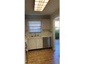 Kitchen features white cabinets, stainless steel dishwasher, and tile flooring at 6070 80Th N St # 109, St Petersburg, FL 33709