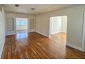 Open-concept living room showcasing hardwood floors, built-in shelving and seamless flow to other spaces at 860 16Th S Ave, St Petersburg, FL 33701
