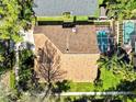 Aerial view of the home showcasing the roof, backyard pool, landscaping, and overall lot layout at 8746 Tantallon Cir, Tampa, FL 33647