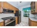 Efficient kitchen features stainless steel appliances and light oak cabinets at 9214 Mission Oaks Blvd, Seminole, FL 33776