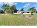 Well-maintained home with a spacious front yard, arched gate and mature trees at 1006 Mandalay Dr, Brandon, FL 33511