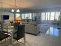 Living room featuring a dining table, couch, and access to a patio at 10351 Regal Dr # 18, Largo, FL 33774