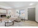 Inviting living room featuring a stone fireplace, neutral sofa, and modern decor at 10686 110Th Ln, Largo, FL 33778