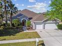 Beautiful single-story home with a three car garage, a well-manicured lawn, and mature landscaping at 12304 Silton Peace Dr, Riverview, FL 33579
