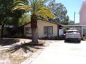 Charming single-story home with a carport, driveway, and mature landscaping at 1436 Ohio Ave, Palm Harbor, FL 34683