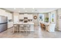 Modern kitchen with stainless steel appliances, a large island, and an adjacent dining area at 19664 Gladeview Way, Land O Lakes, FL 34638