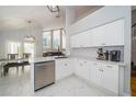 Bright kitchen featuring white cabinets, stainless appliances, and eat-in dining area at 2206 Green Oaks Ln, Tampa, FL 33612