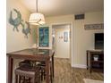 Quaint dining area adjacent to the living room, featuring a table set for four with unique decor at 2211 Belleair Rd # D12, Clearwater, FL 33764
