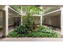 Beautiful building atrium with benches, a fountain, and lush plant life at 3325 Bayshore Blvd # D11, Tampa, FL 33629