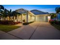 Single-Gathering home with screened garage door, landscaping, and a cozy covered porch at 513 Manns Harbor Dr, Apollo Beach, FL 33572