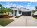 Charming single-Gathering home with a screened garage, tropical landscaping and a cozy porch at 513 Manns Harbor Dr, Apollo Beach, FL 33572