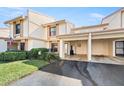 Two-story townhouse featuring covered parking, manicured lawn, and an American flag at 6140 Sun Blvd # 5, St Petersburg, FL 33715