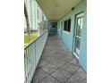 Hallway view with railing, tiled floor, and water view at 6201 2Nd E St # 89, St Pete Beach, FL 33706
