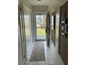 View of a white-tiled hallway leading to the entrance at 6201 2Nd E St # 89, St Pete Beach, FL 33706