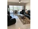 Bright living room with large sliding glass doors to lanai at 6201 2Nd E St # 89, St Pete Beach, FL 33706