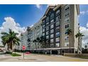 Modern condo building showing multiple floors, covered entry, and street view on a partly cloudy day at 700 S Harbour Island Blvd # 404, Tampa, FL 33602