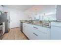 Bright kitchen featuring stainless steel appliances, white cabinets, and granite countertops at 700 S Harbour Island Blvd # 404, Tampa, FL 33602