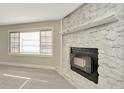 Close up of fireplace with stone surround and modern flooring at 7323 Andre Dr, Zephyrhills, FL 33541