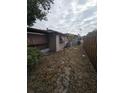 View of the back of the home showing the exterior, foliage and backyard at 7735 Gaston Dr, Port Richey, FL 34668