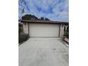 Two car garage and driveway of the home at 7735 Gaston Dr, Port Richey, FL 34668