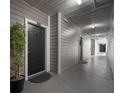 Hallway with apartment door featuring a decorative plant, doormat and unit number at 800 S Dakota Ave # 221, Tampa, FL 33606
