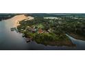 Scenic aerial view of waterfront properties featuring private docks, lush trees, and serene river views at 8910 Eagle Watch Dr, Riverview, FL 33578