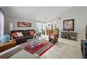 Bright living room with vaulted ceilings and tile flooring, seamlessly connecting to the kitchen at 9122 Suffield Ct, Tampa, FL 33615