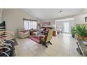 Inviting living room featuring tile floors and a comfortable seating arrangement at 9122 Suffield Ct, Tampa, FL 33615