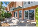 Exterior shot with large sliding glass windows, and a well manicured lawn at 920 N Shore Ne Dr, St Petersburg, FL 33701