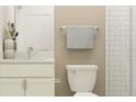 Cozy bathroom featuring neutral colors, vanity with drawers and door, toilet, and white-tiled shower with glass door at 9314 Gladsome Dr, Land O Lakes, FL 34637