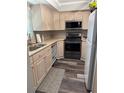 Bright kitchen with wood cabinets, neutral countertops, and stainless steel appliances at 9860 62Nd N Ter # 1036, St Petersburg, FL 33708