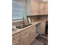 Well-lit kitchen featuring neutral-toned cabinetry, countertops, and modern appliances at 9860 62Nd N Ter # 1036, St Petersburg, FL 33708