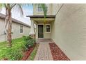 Inviting front porch with manicured landscaping and a brick walkway leads to the front door at 9917 Ivory Dr, Ruskin, FL 33573