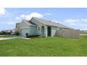Single Gathering home with a green lawn, driveway, and an attached two-car garage at 10914 Penny Gale Loop, San Antonio, FL 33576