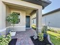 Inviting front entrance with brick walkway and well-maintained landscaping at 120 Moscata Way, Nokomis, FL 34275