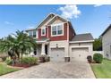 Charming two-story home with a well-manicured lawn, brick driveway, and inviting curb appeal at 12328 Streambed Dr, Riverview, FL 33579