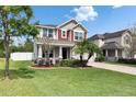 Charming two-story home with a well-manicured lawn and inviting curb appeal at 12328 Streambed Dr, Riverview, FL 33579