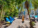 Relaxing backyard retreat with a built-in grill, screened-in pool, and tropical landscaping at 13420 Rustic Pines S Blvd, Seminole, FL 33776