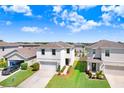 A high-angle view showcases this home's position in a neighborhood with manicured lawns and well-maintained exteriors at 16316 Silent Sands Ln, Odessa, FL 33556