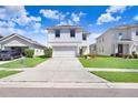 Charming two-story home with a well-manicured lawn and inviting curb appeal, plus an attached two-car garage at 16316 Silent Sands Ln, Odessa, FL 33556