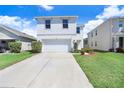 Charming two-story home with a well-manicured lawn and inviting curb appeal, plus an attached two-car garage at 16316 Silent Sands Ln, Odessa, FL 33556