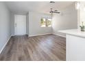 Bright living room boasts modern gray laminate flooring and a ceiling fan at 1766 10Th Sw St, Largo, FL 33778