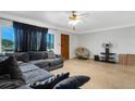 Comfortable living room with light walls, a ceiling fan, and neutral flooring at 1988 58Th N St, St Petersburg, FL 33710